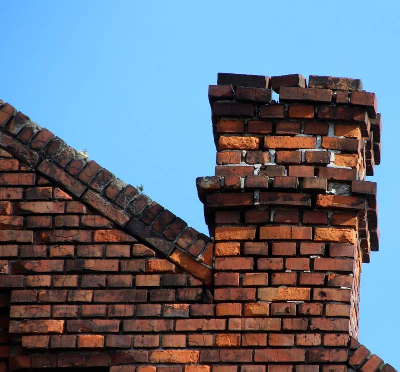 Damaged chimney on an Riverview home showing cracks and missing mortar